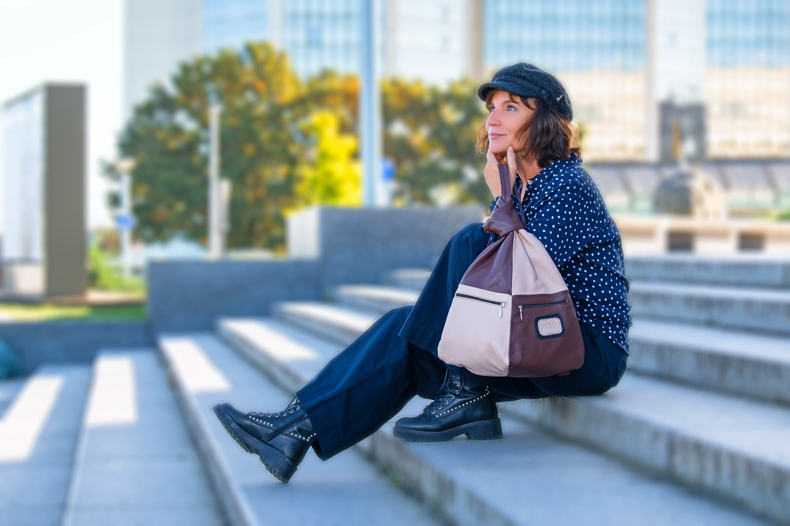 brown beige leather backpack on a sitting woman