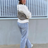 leather fanny pack in taupe color on a woman
