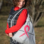 grey artisan leather backpack with a pink ribbon on shoulders of a woman