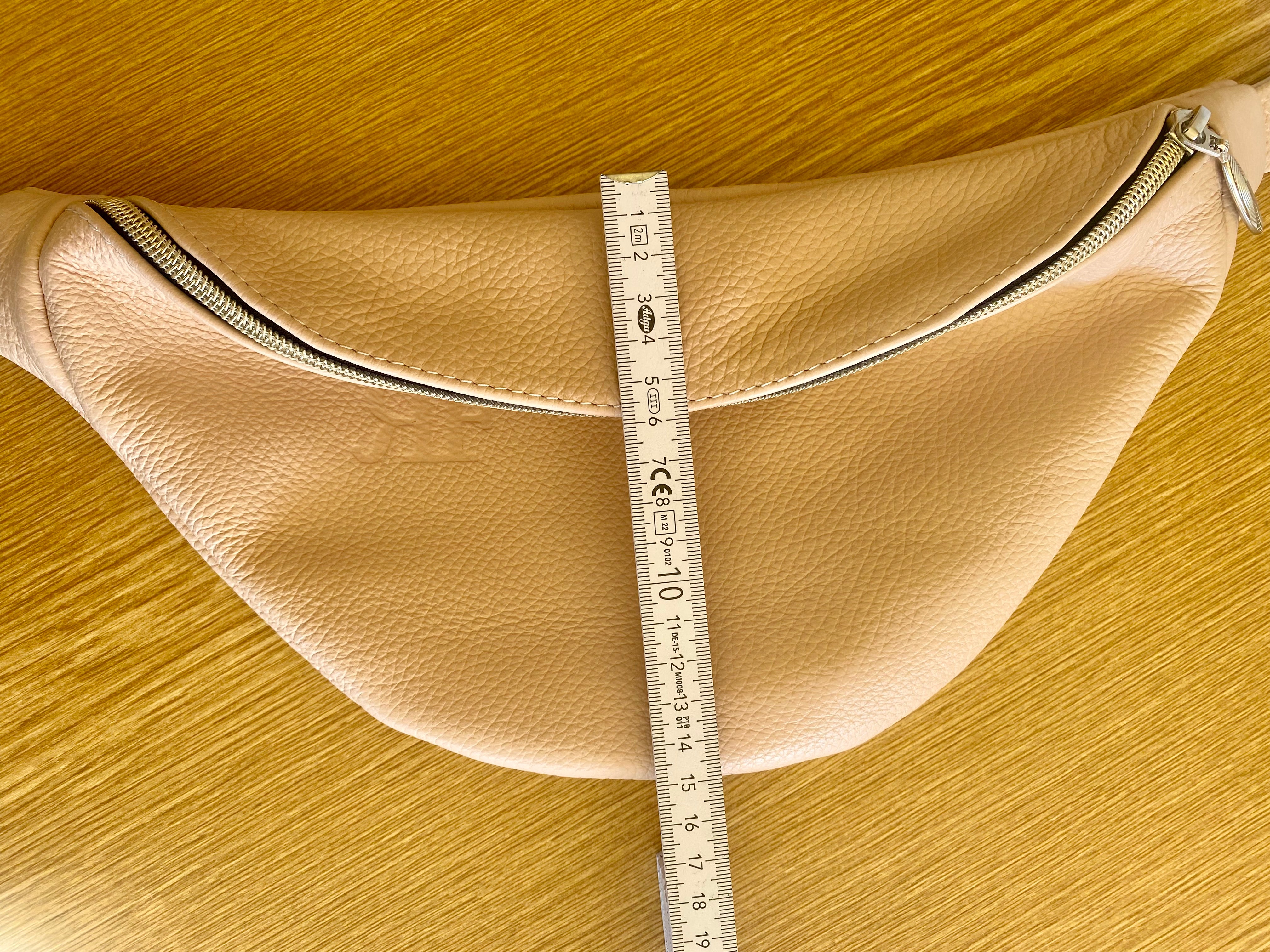 Handmade Leather Bum Bag, Funny Pack in beige color on the table 