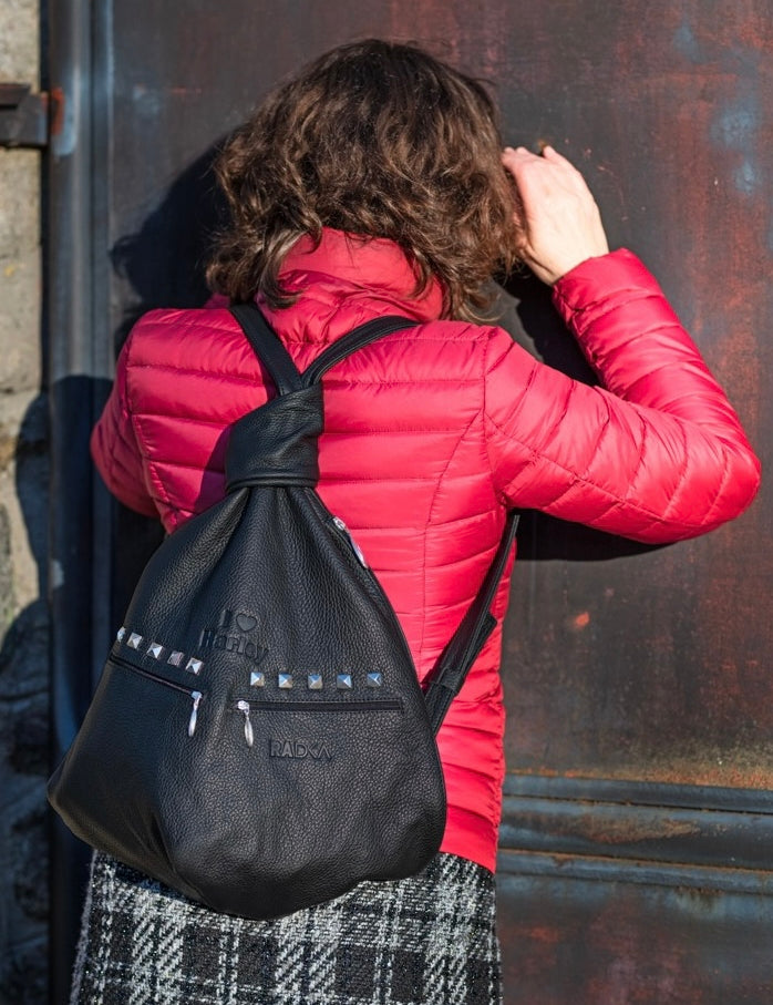 black leather backpack a  rock style on shoulders of a woman