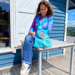Blue leather artisan backpack with hearts with a woman on the table in Sweden