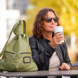 khaki green design handbag on table with a woman