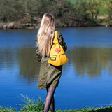 Romantic Handmade Leather Backpack with Heart Detail on shoulder of a woman in the nature