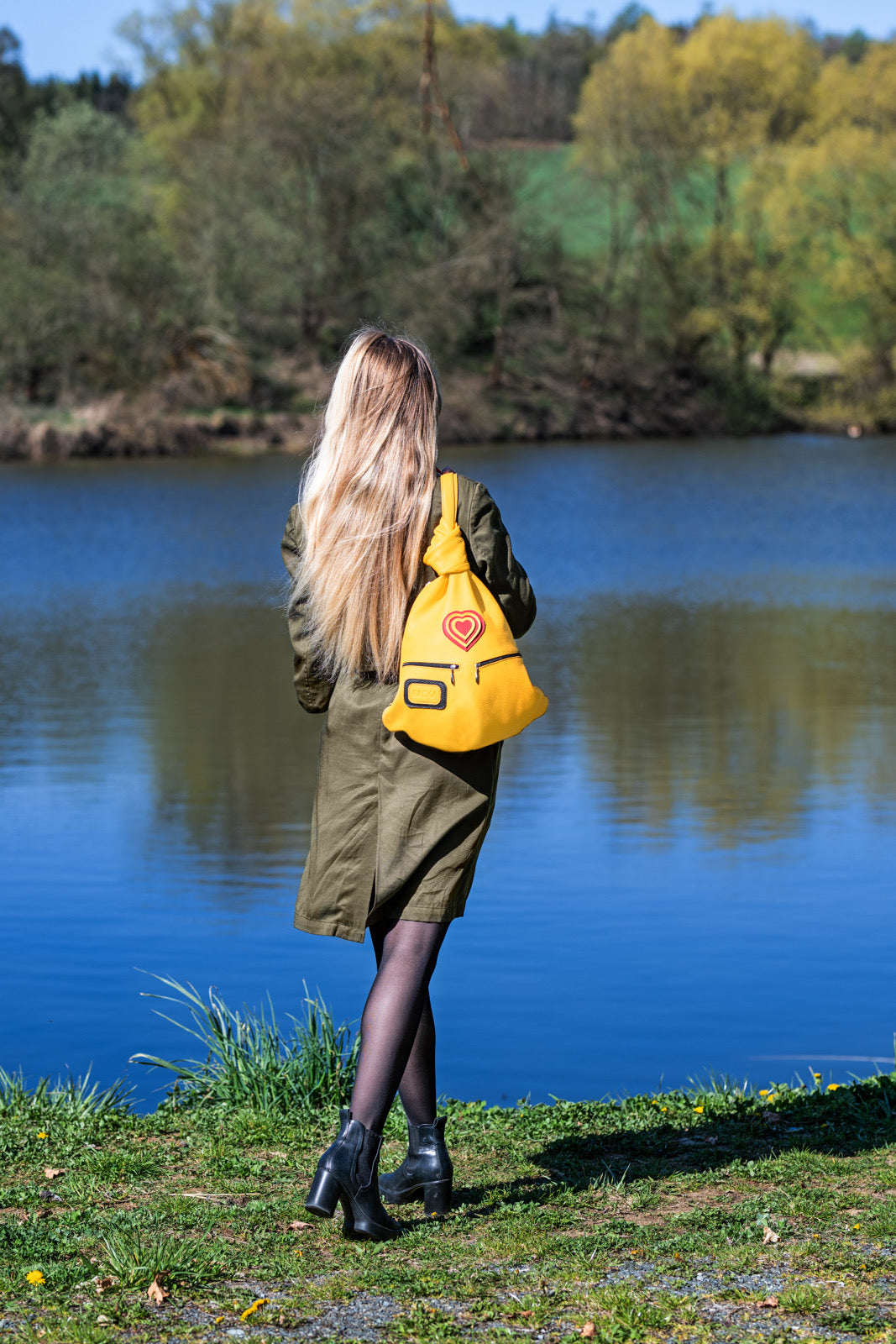 Romantic Handmade Leather Backpack with Heart Detail on shoulder of a woman in the nature